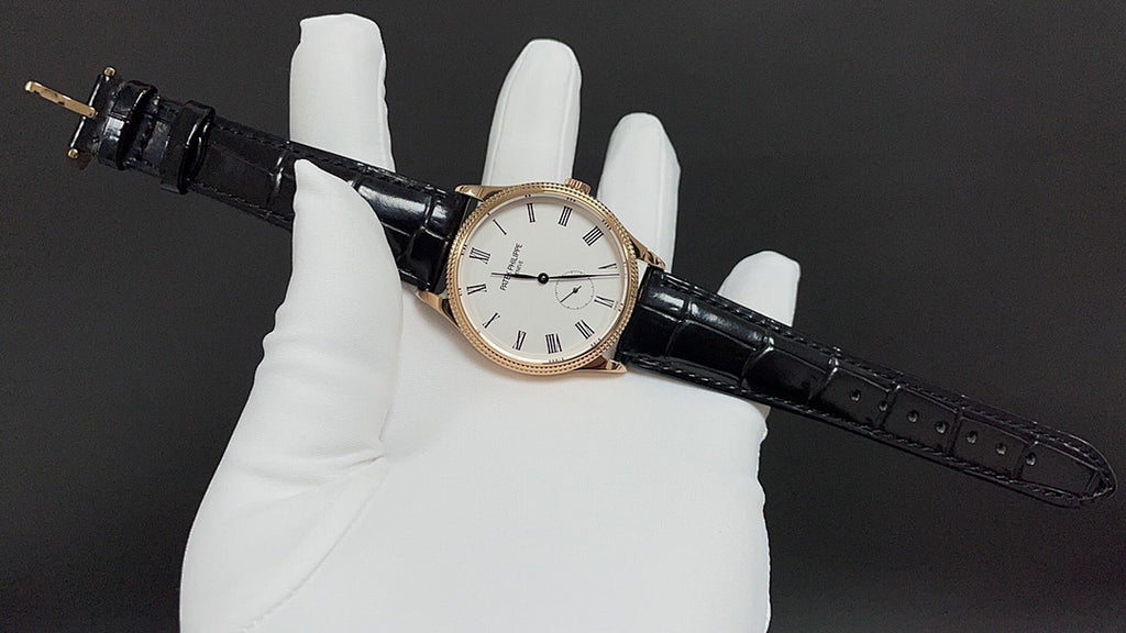 Patek Philippe wristwatch on black leather strap, side profile view