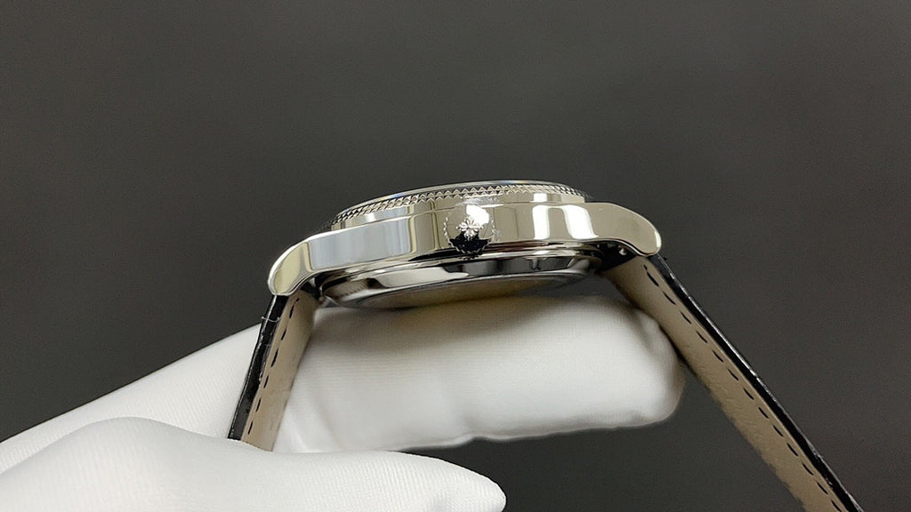 Wristwatch case back close-up with reflective silver bezel and metal lugs