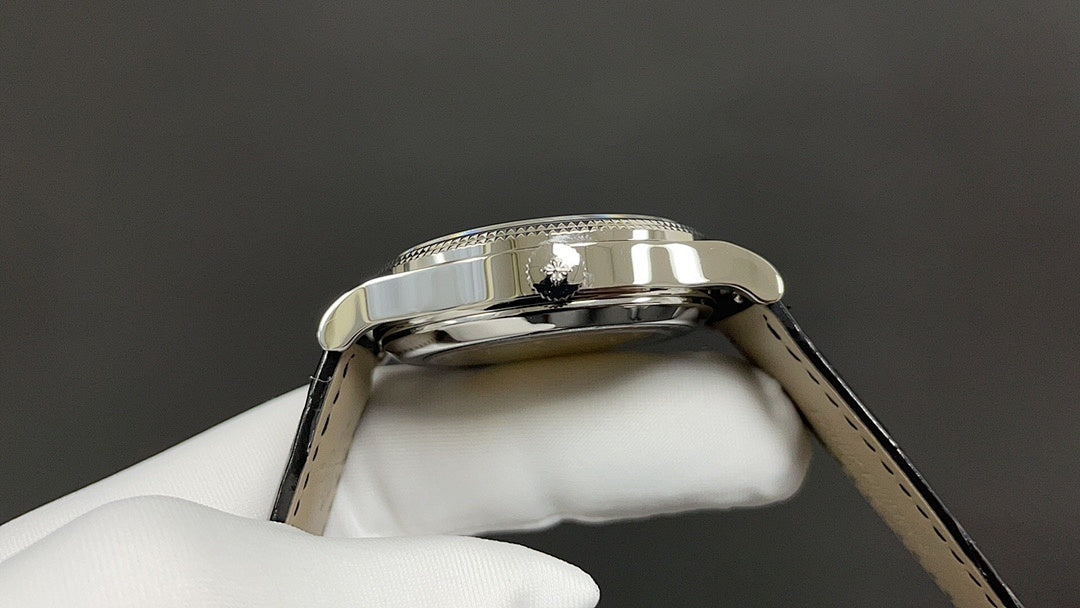 Wristwatch case back close-up with reflective silver bezel and metal lugs