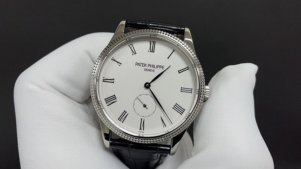 Wristwatch with white dial, Roman numerals, black leather strap, three-hand layout
