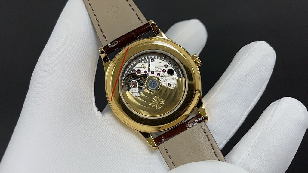 Patek Philippe watch with exposed movement view, gold case, brown leather strap