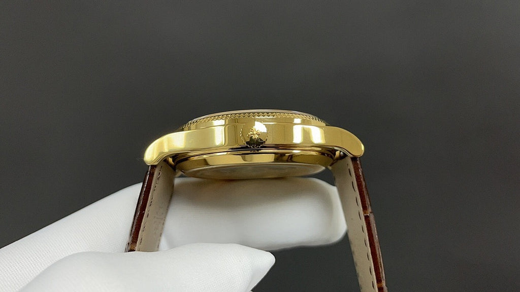 Patek Philippe watch back view, gold caseback and brown leather strap
