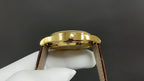 Patek Philippe watch back view, gold caseback and brown leather strap