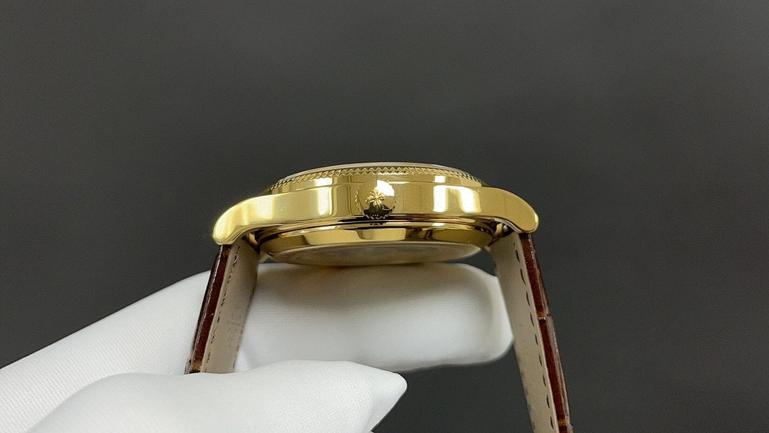 Patek Philippe watch back view, gold caseback and brown leather strap