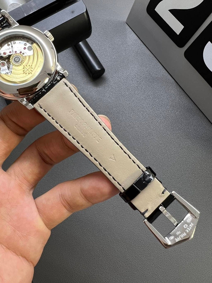 Patek Philippe wristwatch with cream leather strap and polished silver buckle