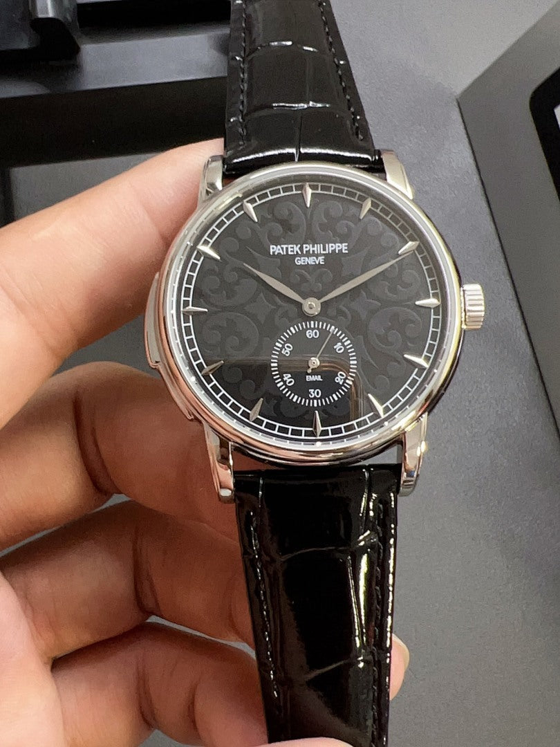 Patek Philippe wristwatch with black leather strap and dark gray dial, silver bezel