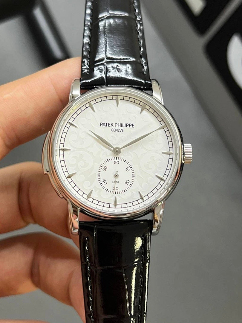 Patek Philippe watch with black leather strap and silver-tone case, white dial with subdial details