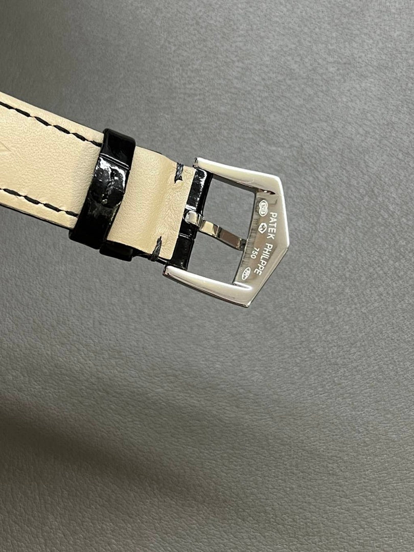 Patek Philippe watch strap buckle with black leather and light stitching on clasp