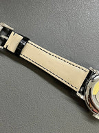 Patek Philippe watch strap with light stitching and printed leather branding near case