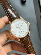 Patek Philippe round wristwatch with white dial, brown leather strap, gold-tone case