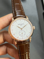 Round wristwatch front with white dial, gold-tone case, brown leather strap