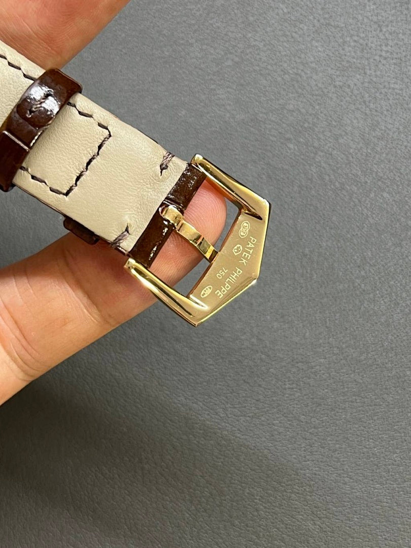 Patek Philippe watch buckle with brown leather strap and gold clasp