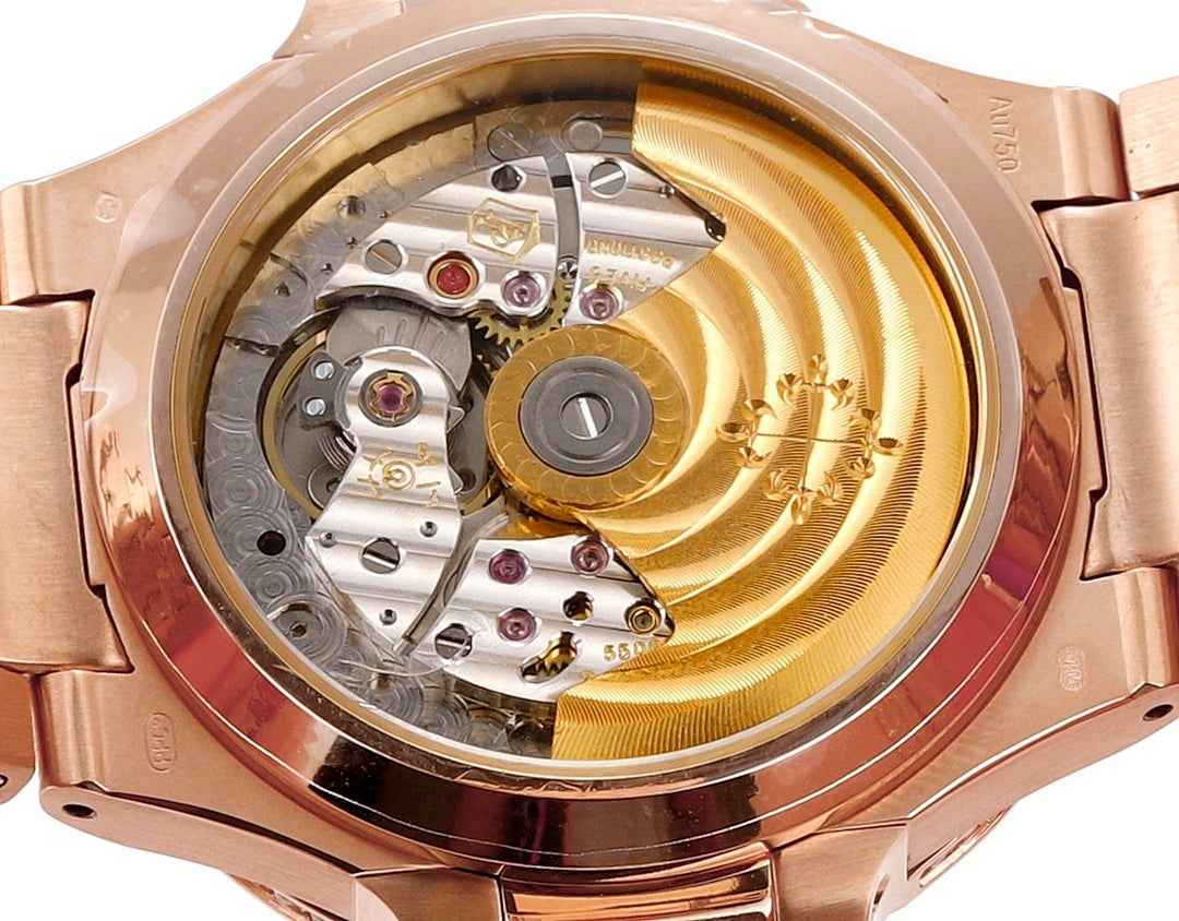 Rose gold watch caseback with visible mechanical movement and crown-side details