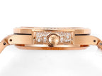 Rose gold watch case side profile with crown and diamond bezel accents