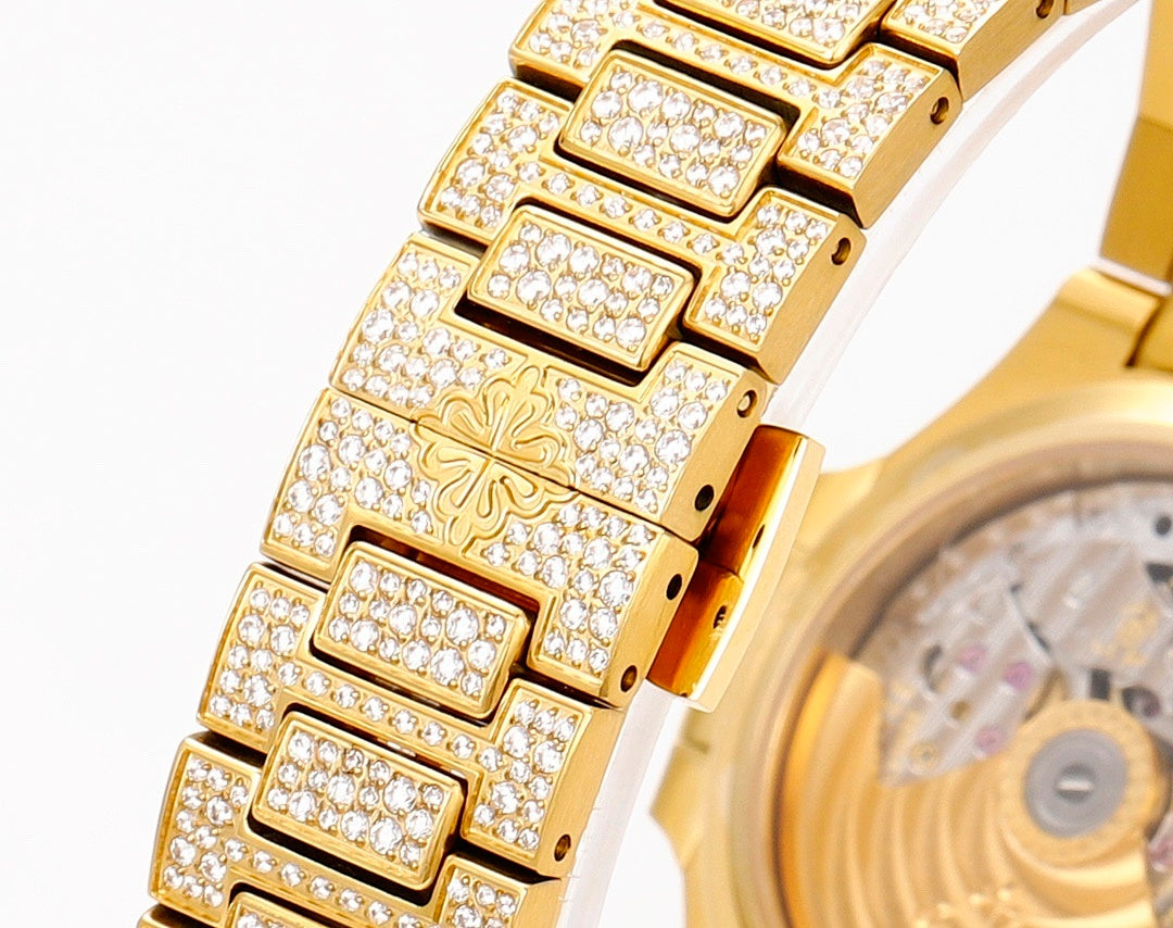 Patek Philippe gold watch bracelet with diamond-set links and engraved center panels