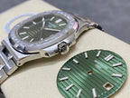 Patek Philippe steel wristwatch with green dial, diamond bezel detail, and crown