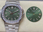 Patek Philippe steel wristwatch with green dial, diamond bezel, and date window