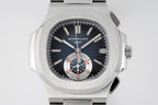 Patek Philippe wristwatch front close-up with dark dial, subdials, and date window