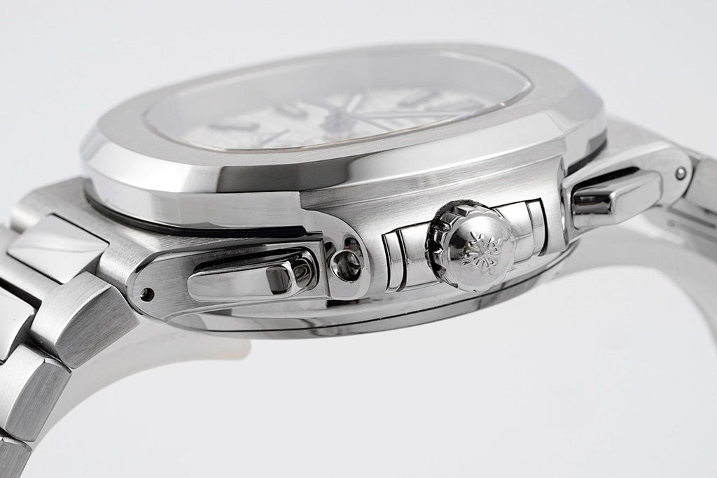 Stainless steel watch case close-up with crown and pushers on the side.