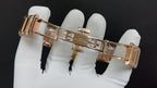 Rose-gold wristwatch with metal link bracelet and clasp, side view