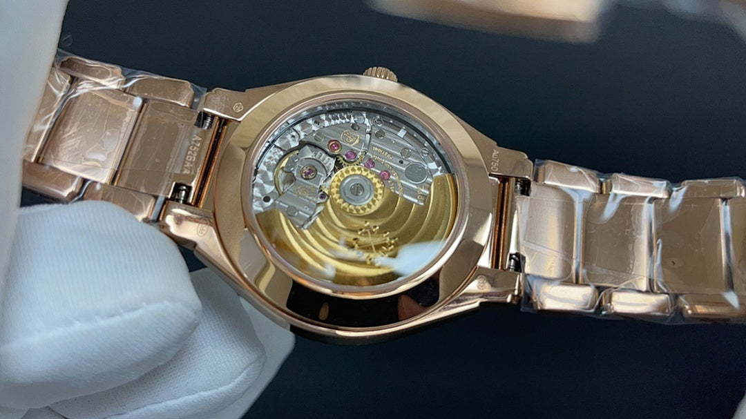 Gold-tone wristwatch with visible mechanical movement through clear caseback