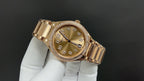Gold-tone wristwatch angled view with champagne dial and diamond bezel
