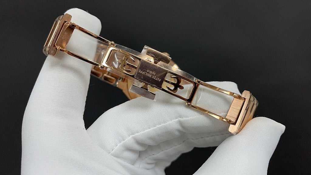 Gold-tone Patek Philippe watch with hinged clasp and rectangular bracelet links