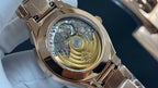 Patek Philippe watch caseback with visible mechanical movement beneath crystal