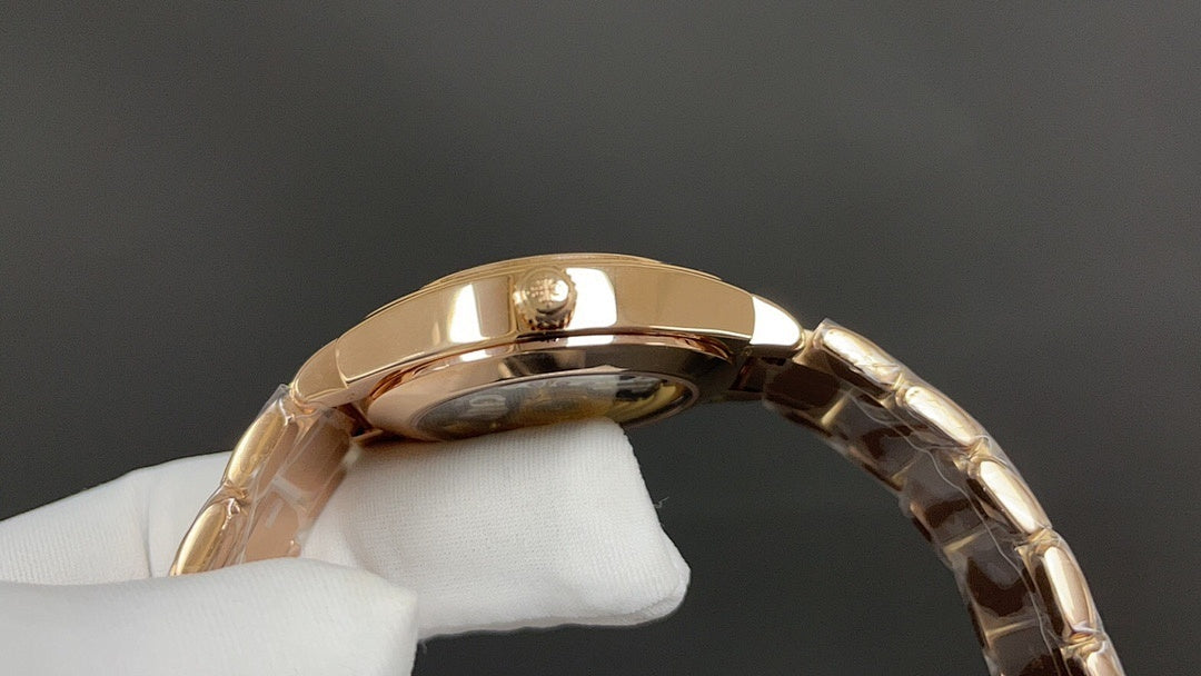 Gold-tone Patek Philippe watch side profile with crown and polished metal links