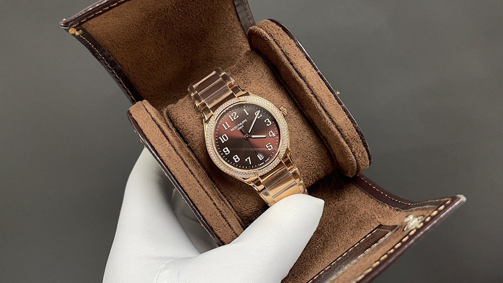 Brown leather-strap Patek Philippe watch with gold-tone case and dark dial