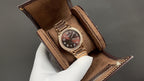 Brown leather-strap Patek Philippe watch with gold-tone case and dark dial