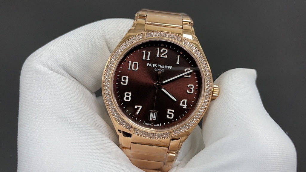 Gold-tone Patek Philippe watch with brown dial, raised numerals, and diamond bezel