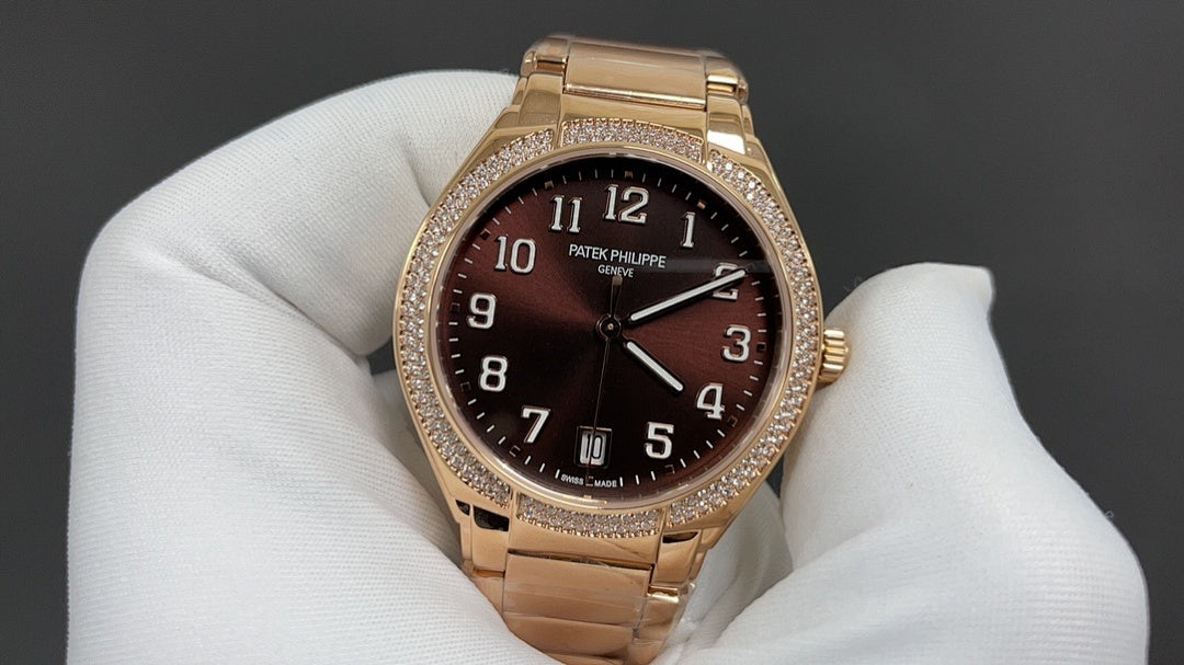 Gold-tone Patek Philippe watch with brown dial, raised numerals, and diamond bezel