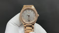 Patek Philippe watch in rose-gold tone with diamond bezel and bracelet, white dial.