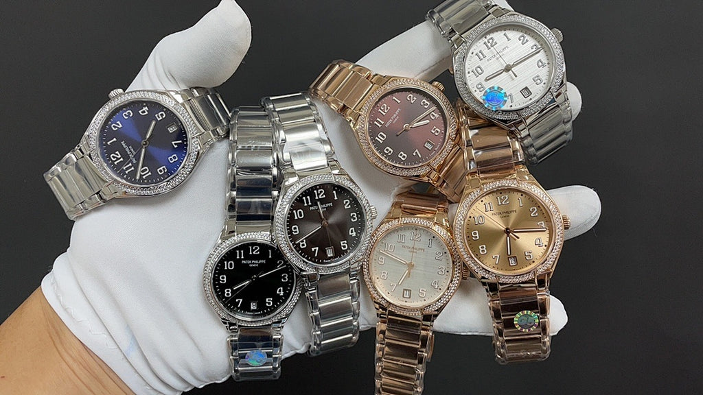 Multiple Patek Philippe watches with metal bracelets, blue, black, and gold-toned dials.