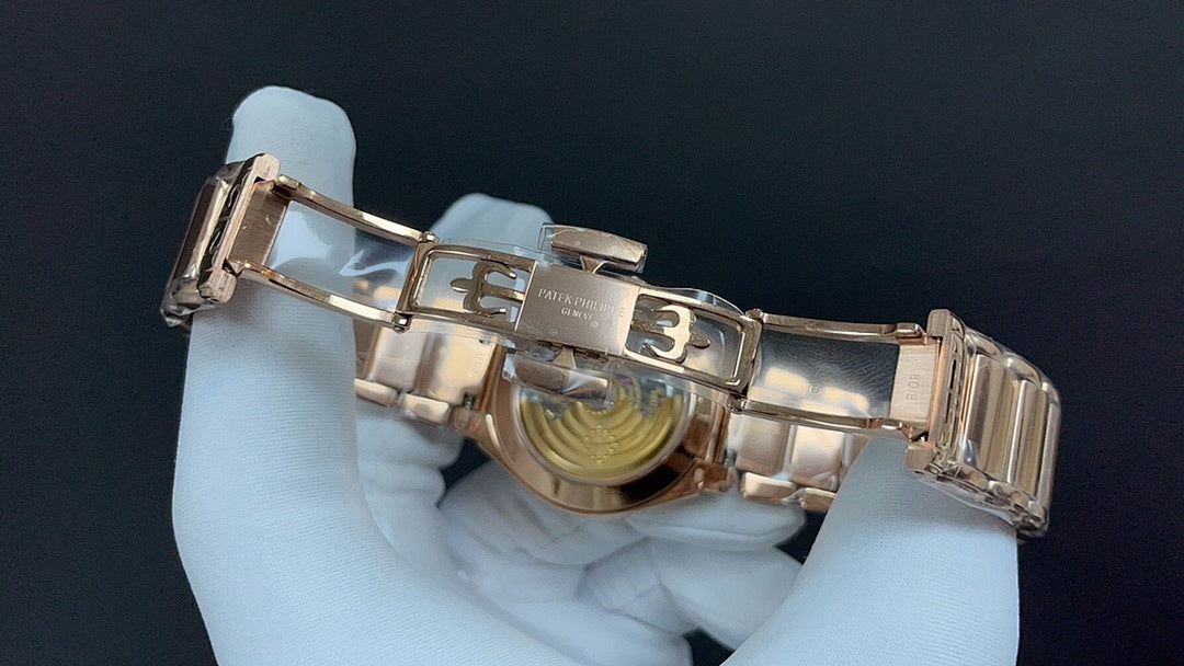 Patek Philippe watch bracelet clasp with polished metal links and hinged deployant.