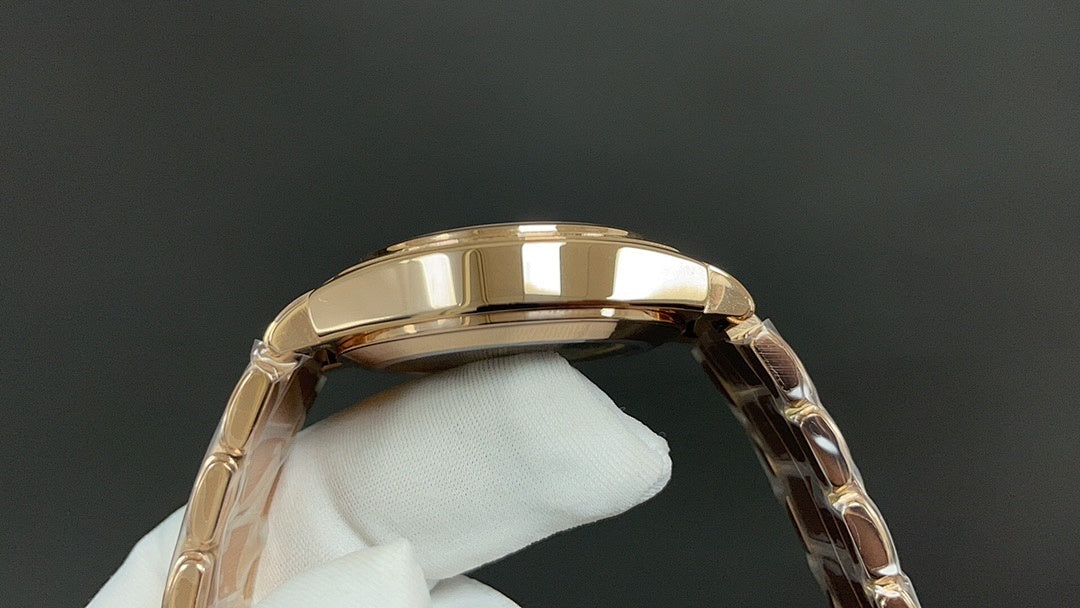 Patek Philippe watch case top in gold tone with metal bracelet links.