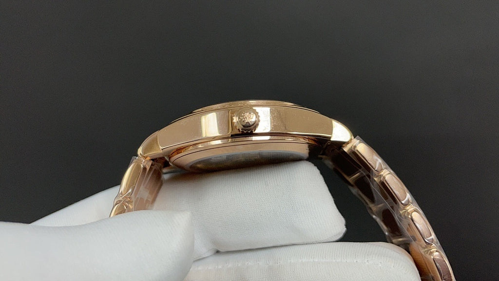 Patek Philippe watch side profile in gold tone with metal bracelet links.