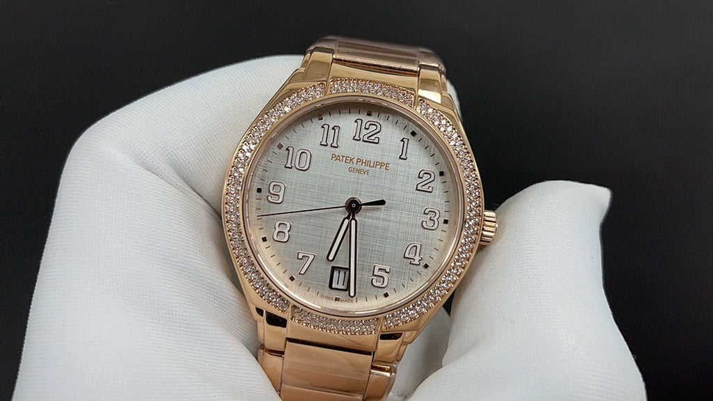 Patek Philippe watch rose-gold tone with diamond bezel, white dial and black numerals.