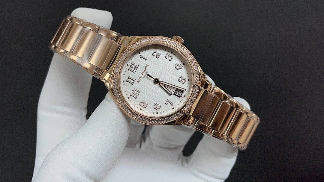 Patek Philippe watch on white glove, rose-gold metal bracelet with diamond bezel.