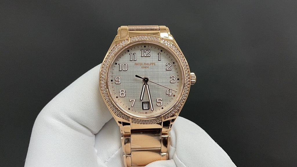 Patek Philippe watch rose-gold tone with jeweled bezel, white dial, and metal bracelet.