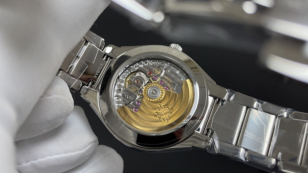 Patek Philippe watch with visible mechanical movement on silver metal case.