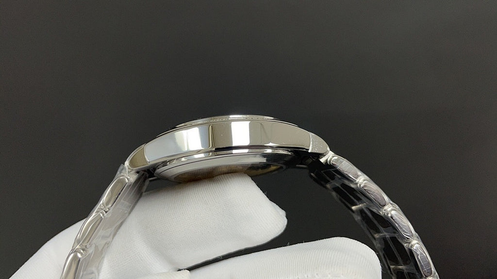 Patek Philippe watch case and bezel, silver metal with curved profile.