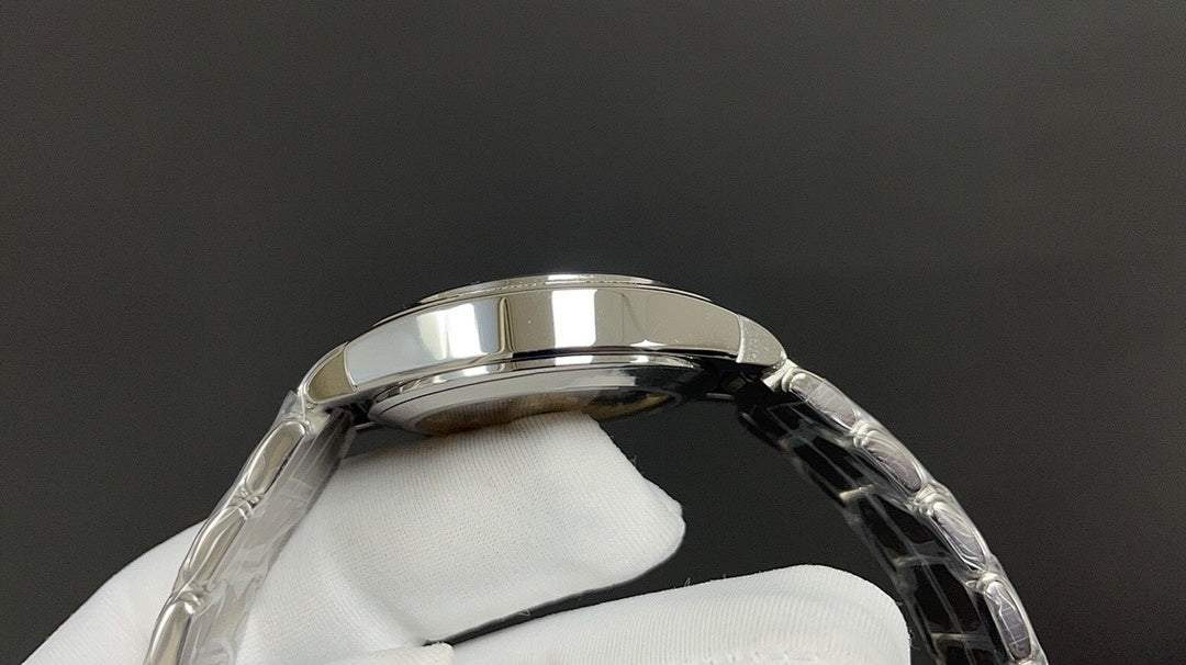 Patek Philippe watch case and bezel, silver metal with curved profile.