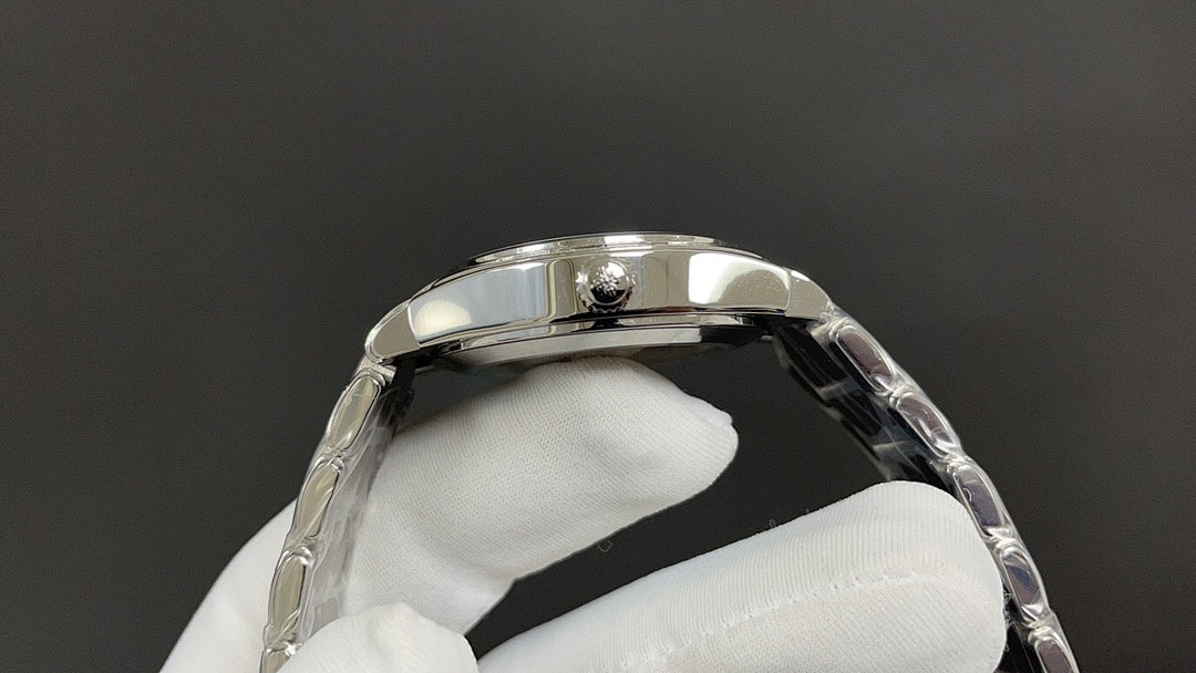 Patek Philippe watch bezel and side profile, silver metal case.