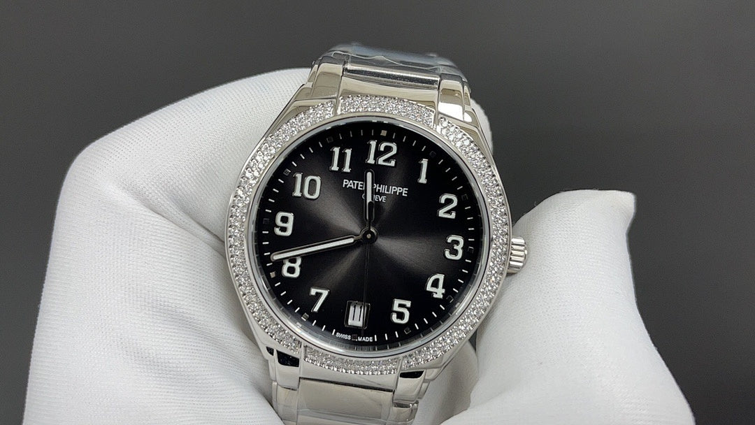 Patek Philippe watch with black dial, silver bracelet, diamond bezel.