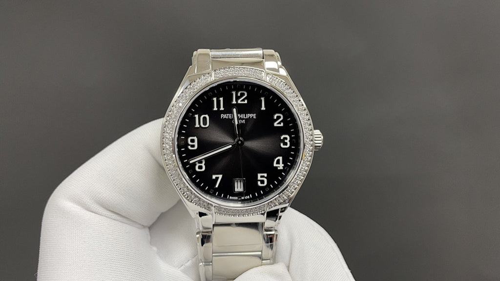 Patek Philippe watch close-up on hand with black dial and diamond bezel.