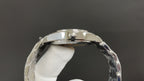 Silver watch caseback with metal rim and glass window