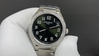 Patek Philippe wristwatch with black dial, silver bracelet, and diamond bezel