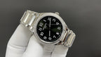 Patek Philippe wristwatch angled view with black dial and silver diamond bezel